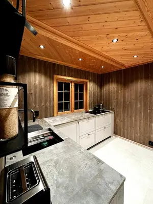 a large kitchen with wooden ceilings and a counter top at Nature-Close Cabin By Trysil Mountain in Trysil