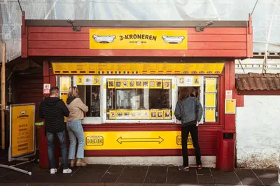 a group of people standing outside of a food truck at Bergen Beds Apartments - Unbeatable location! in Bergen