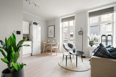 a living room with a couch and a table at Bergen Beds Apartments - Unbeatable location! in Bergen