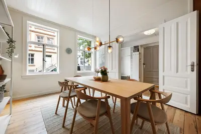 a dining room with a wooden table and chairs at Authentic Bergen Apartment in Bergen