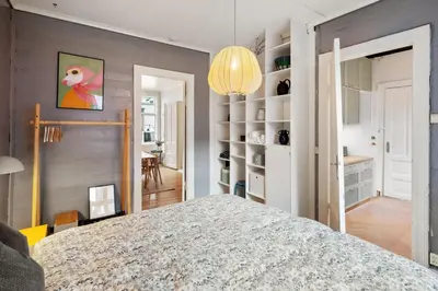 a bedroom with a bed and a dining room at Authentic Bergen Apartment in Bergen