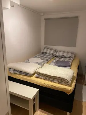 a bed with two pillows on it in a room at Lade - Aqua Nor 2025 - inntil 7 personer in Lii