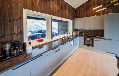 a large kitchen with white cabinets and a window at Nice Home In Hafslo With Wifi in Hafslo