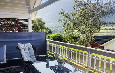 a patio with a table and chairs on a balcony at 3 Bedroom Amazing Home In Elnesvågen in Sylte