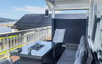 a patio with a table and chairs on a balcony at 3 Bedroom Amazing Home In Elnesvågen in Sylte