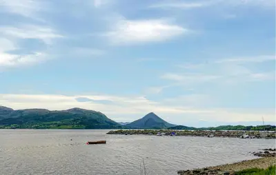 a large body of water with mountains in the background at 3 Bedroom Amazing Home In Elnesvågen in Sylte