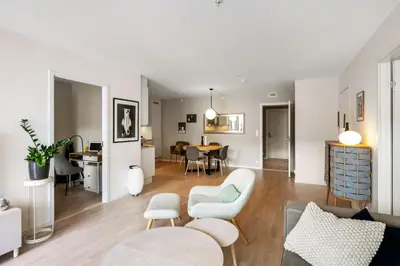 a living room with a couch and a table at Roomsly Apartments - City flat with Private Balcony in Bergen