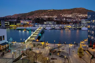 a view of a city with a marina at night at Roomsly Apartments - City flat with Private Balcony in Bergen