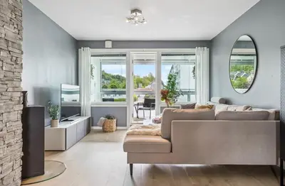 a living room with a couch and a fireplace at Downtown apartment with a view in Bergen