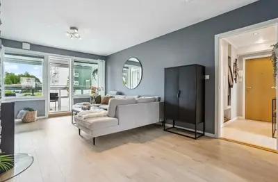 a living room with a couch and a mirror at Downtown apartment with a view in Bergen