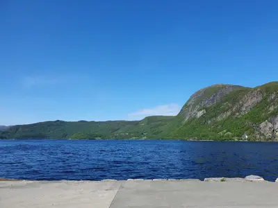 a large body of water with mountains in the background at Feriehus Rodal med Båt in Rodal