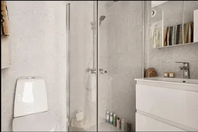 a bathroom with a shower with a toilet and a sink at Studio apartment centrally located in Bergen in Bergen