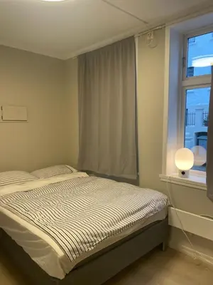 a bedroom with a bed in front of a window at Studio apartment centrally located in Bergen in Bergen