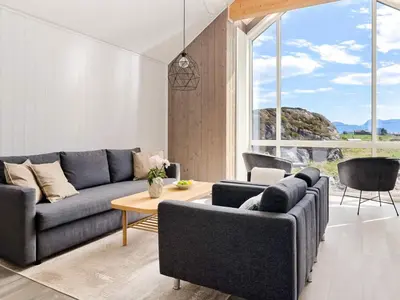 a living room with a couch and a table at 8 person holiday home in Sandøy in Finnøy