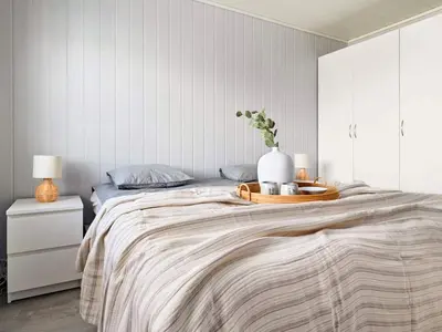 a bedroom with a bed with a tray with a vase on it at 8 person holiday home in Sandøy in Finnøy