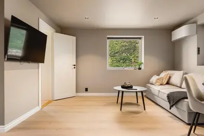 a living room with a couch and a table at Trolltunga Fjord Stay in Odda
