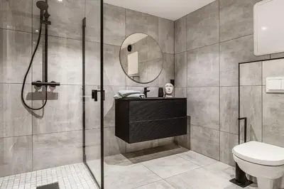 a bathroom with a shower and a sink and a toilet at Trolltunga Fjord Stay in Odda