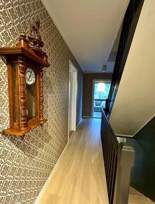 a stairway with a clock on the wall at Spacious holiday home by the fjord and mountains in Sæbø