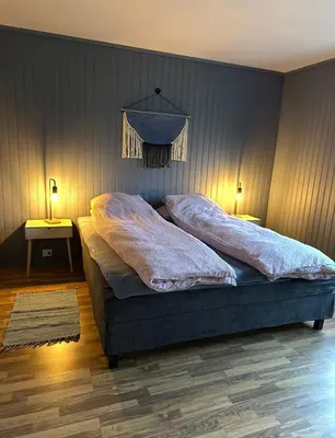 a bed with two pillows on it in a bedroom at Spacious holiday home by the fjord and mountains in Sæbø