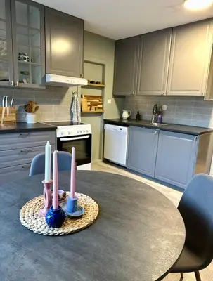 a kitchen with a table with candles on it at Spacious holiday home by the fjord and mountains in Sæbø