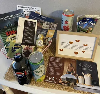 a table with a bunch of food and drinks at Bright & Spacious Apartment by the Sea, Free Parking, 10min to Airport, 12min to Ålesund in Ytterland