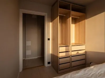 a bedroom with a closet with wooden cabinets at Apartment in the heart of Ålesund city in Ålesund