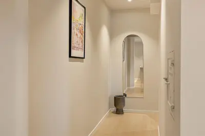 a hallway with white walls and an archway at Apartment in the heart of Ålesund city in Ålesund