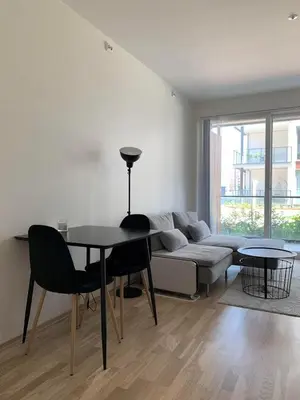 a living room with a table and a couch at New and modern apartment in Trondheim, Øvre Nyhavna in Trondheim
