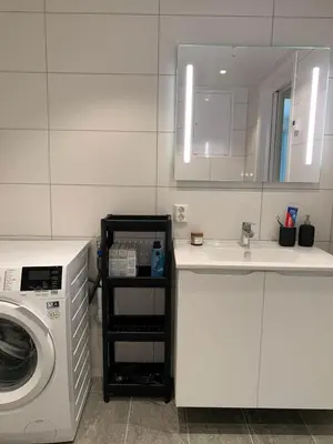 a kitchen with a washing machine and a sink at New and modern apartment in Trondheim, Øvre Nyhavna in Trondheim
