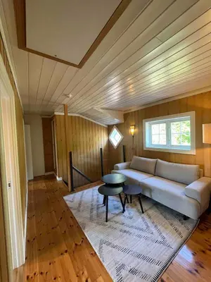 a living room with a couch and a table at Traditional Norwegian Villa, Bay view and boat in Bergen