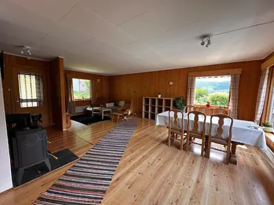 a living room with a bed and a table and chairs at Family house near Kvitfjell & Hunderfossen in Fåvang