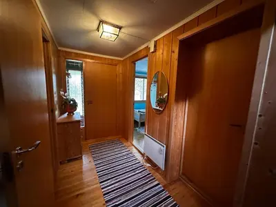 a hallway of a house with a door and a rug at Family house near Kvitfjell & Hunderfossen in Fåvang