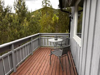 a patio with a table and chairs on a porch at Family house near Kvitfjell & Hunderfossen in Fåvang