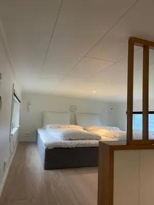 a bedroom with two beds and a mirror at Olden Tinyhouse - Modern Living in Olden
