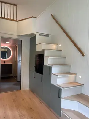 a kitchen with a staircase in a house at Olden Tinyhouse - Modern Living in Olden