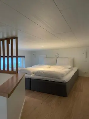 a bedroom with a large bed in a room at Olden Tinyhouse - Modern Living in Olden
