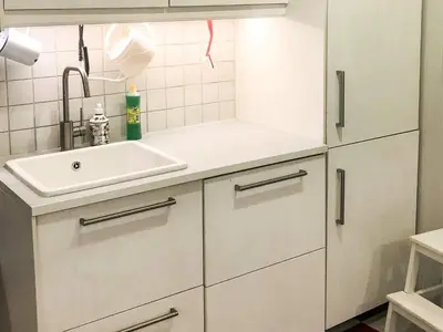 a white kitchen with a sink and a counter at 6 person holiday home in Lillehammer in Lillehammer