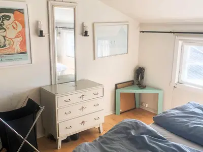 a bedroom with a dresser and a mirror and a bed at 6 person holiday home in Lillehammer in Lillehammer