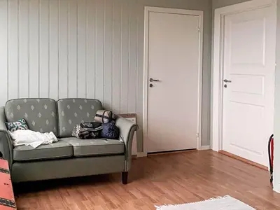 a child laying on a couch in a living room at 8 person holiday home in hauglandshella