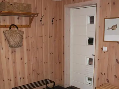 a room with a wooden wall with a door at 10 person holiday home in NORDTORPA in Nord Torpa