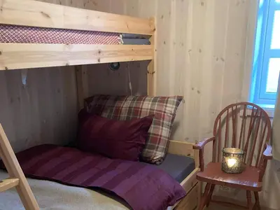 a bunk bed and a chair in a room at 10 person holiday home in NORDTORPA in Nord Torpa