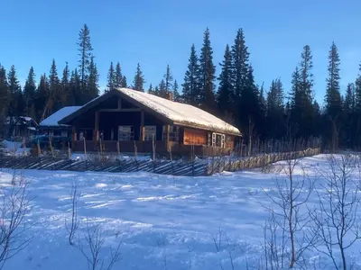 a log cabin in the snow with a lot of snow at 10 person holiday home in NORDTORPA in Nord Torpa
