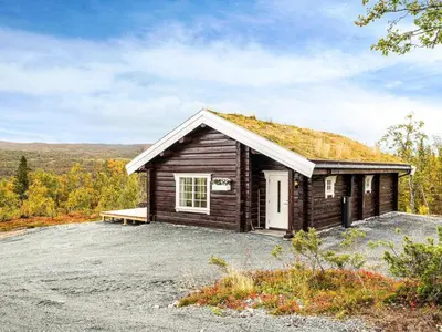 a small log cabin with a grass roof at 8 person holiday home in Ålen in Ålen
