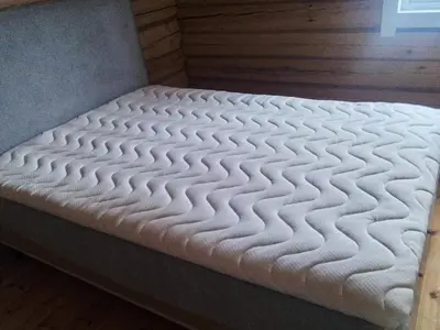 a bed with a white mattress in a room at 8 person holiday home in Ålen in Ålen