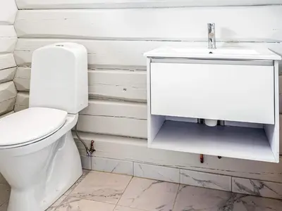 a white bathroom with a toilet and a sink at 8 person holiday home in Ålen in Ålen