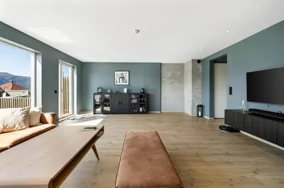 a living room with a couch and a flat screen tv at House with outdoor area in Ålesund