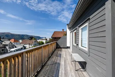 a balcony with a bench on the side of a building at House with outdoor area in Ålesund