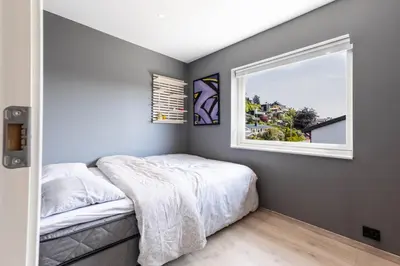 a bedroom with a bed and a window at House with outdoor area in Ålesund