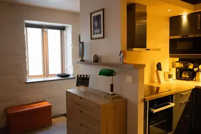 a kitchen with a desk with a green lamp on it at Private Apartment in Bergen in Bergen