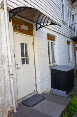 a garage with a white door and a building at Private Apartment in Bergen in Bergen